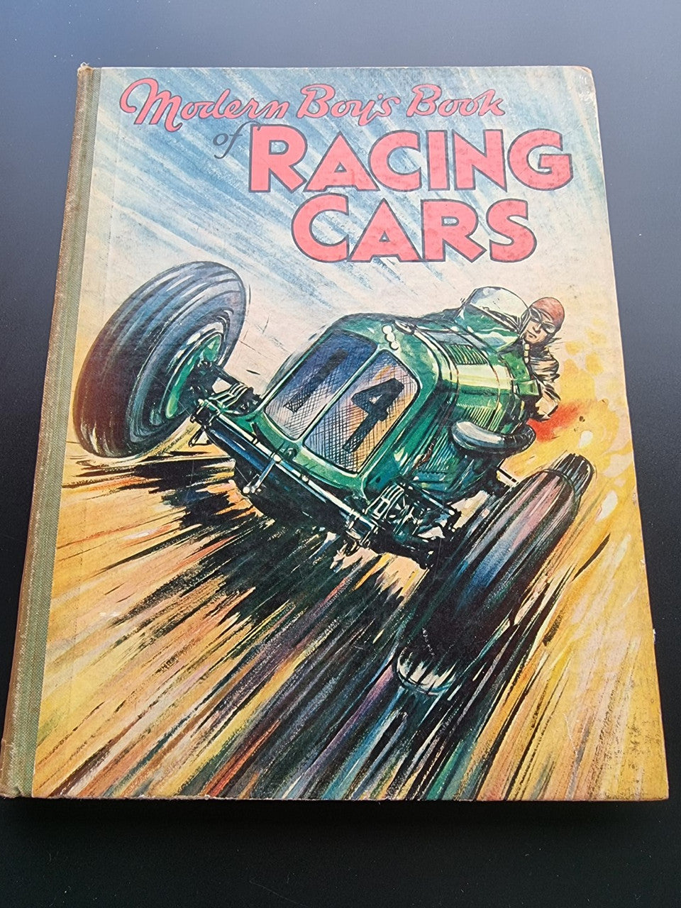 Racing cars hardcover book cover with green race car illustration and title text.