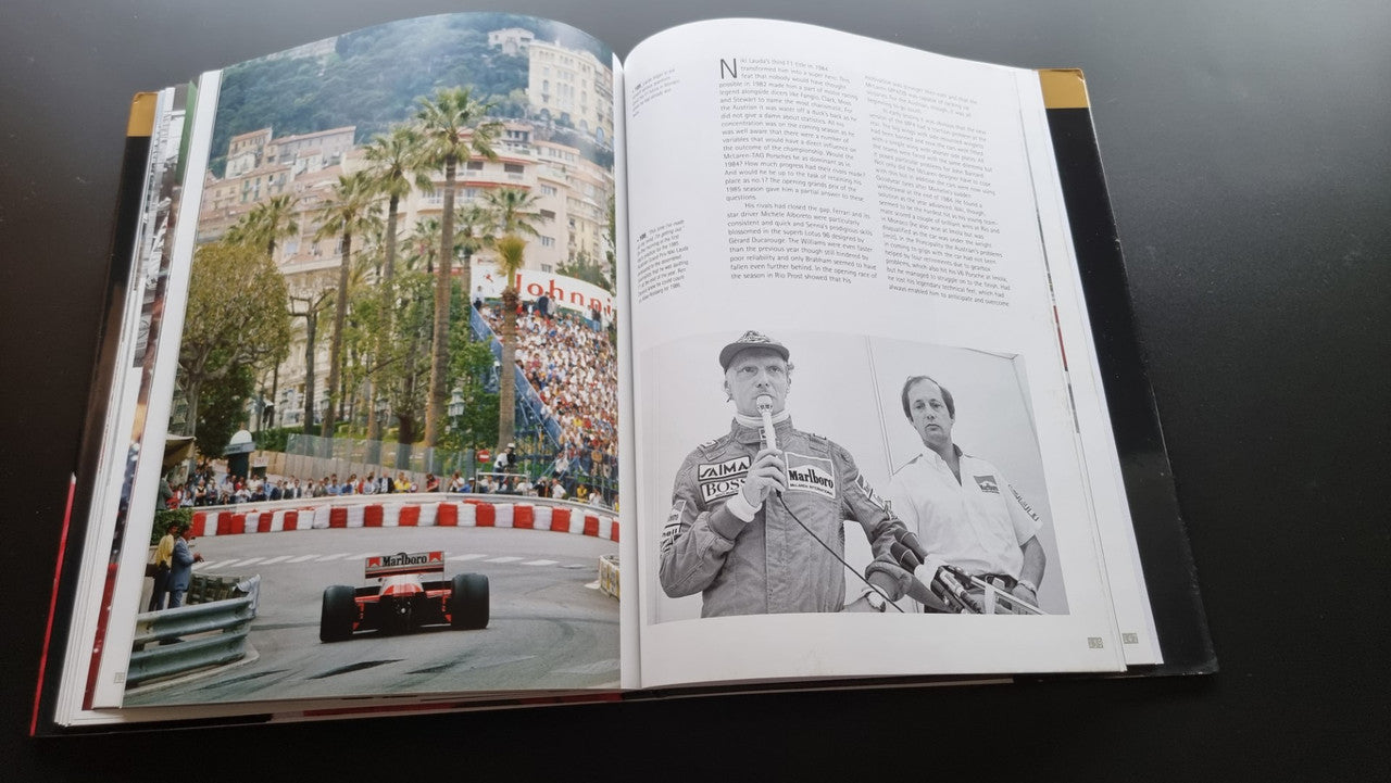 Open biography book with color grandstand photo and black-and-white driver portrait