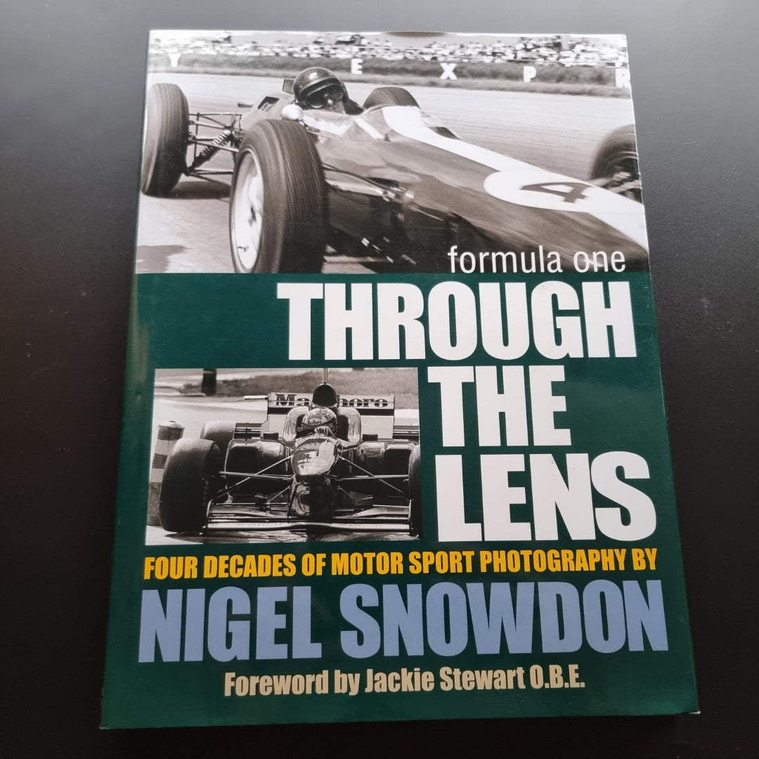 Signed motor sport photography book with green cover and bold title text