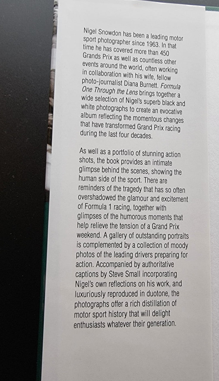 Motor sport photography book page with printed biography text in paragraphs