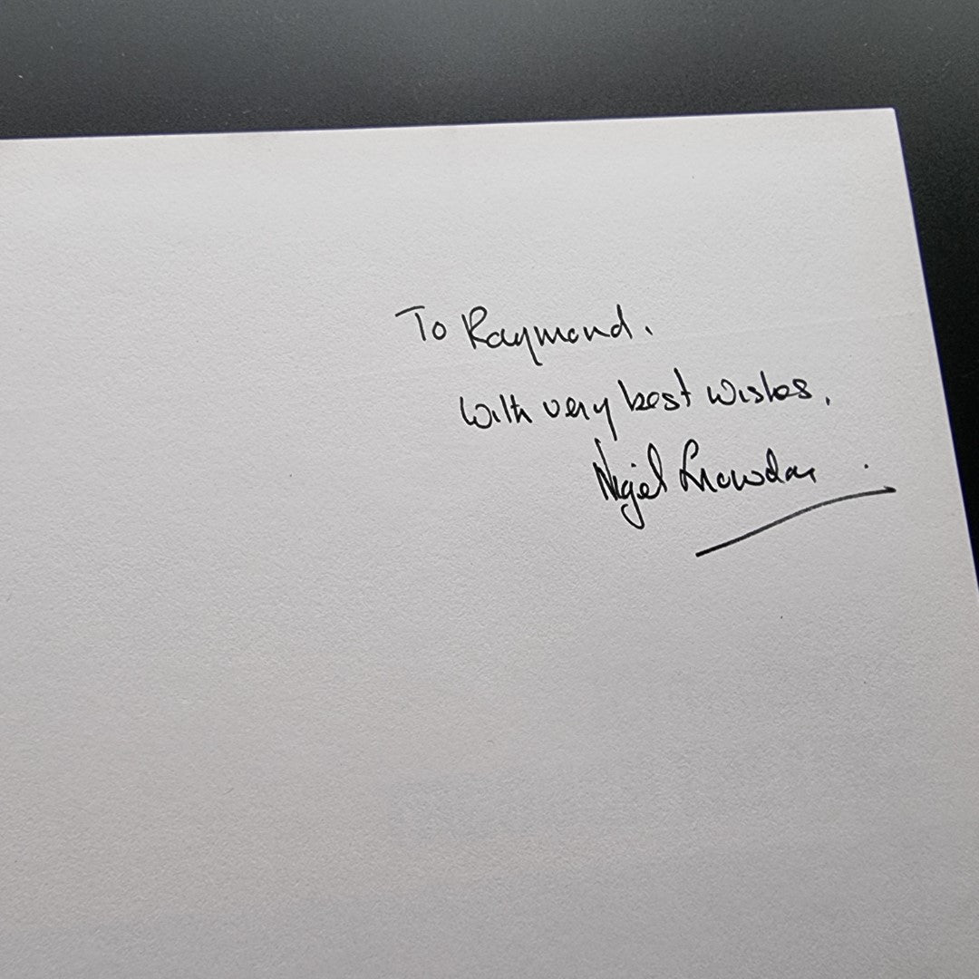Signed dedication page with handwritten message and signature on white paper