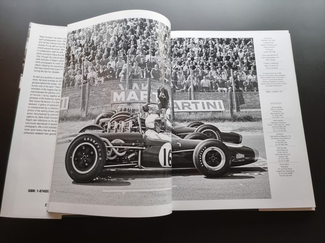 Open motor sport photography book with black-and-white race car photos on two pages