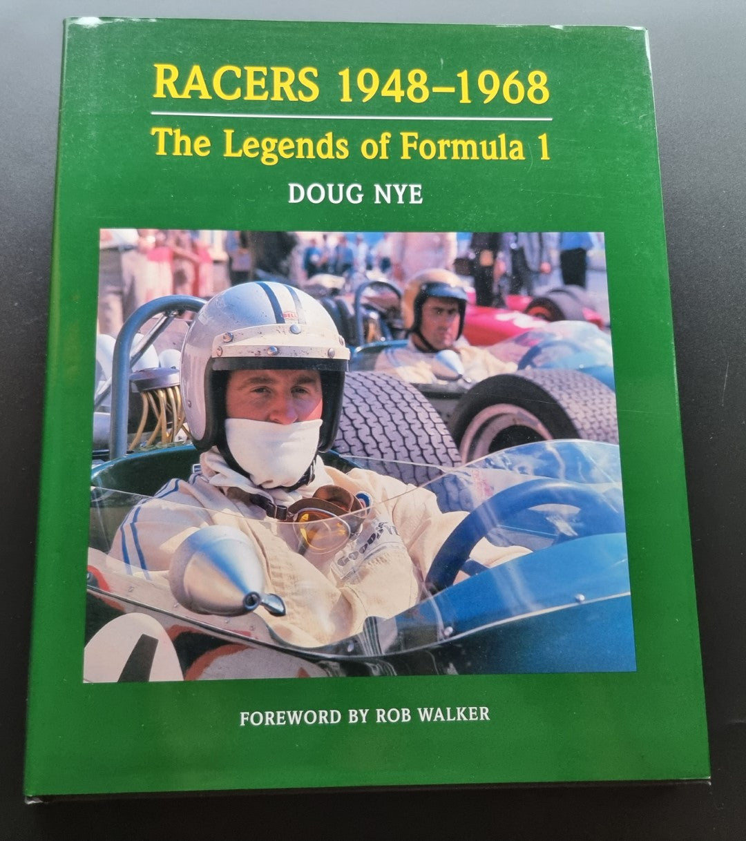 Green hardcover book with racing driver photo on the front cover.