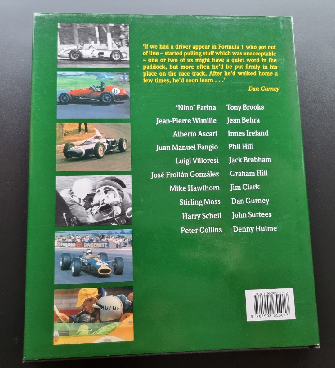 Back cover of a green hardcover racing book with small car and quote panels.