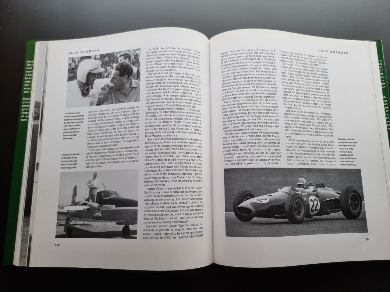 Open motorsport history book with black-and-white Formula 1 driver and car photos