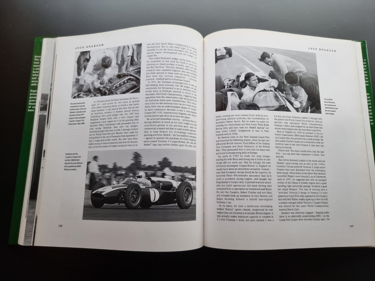 Open motorsport history book with black-and-white Formula 1 car and team photos