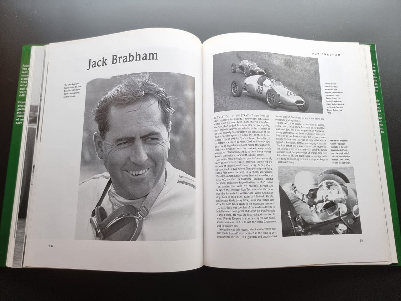 Open motorsport history book with portrait of Jack Brabham and black-and-white race photos