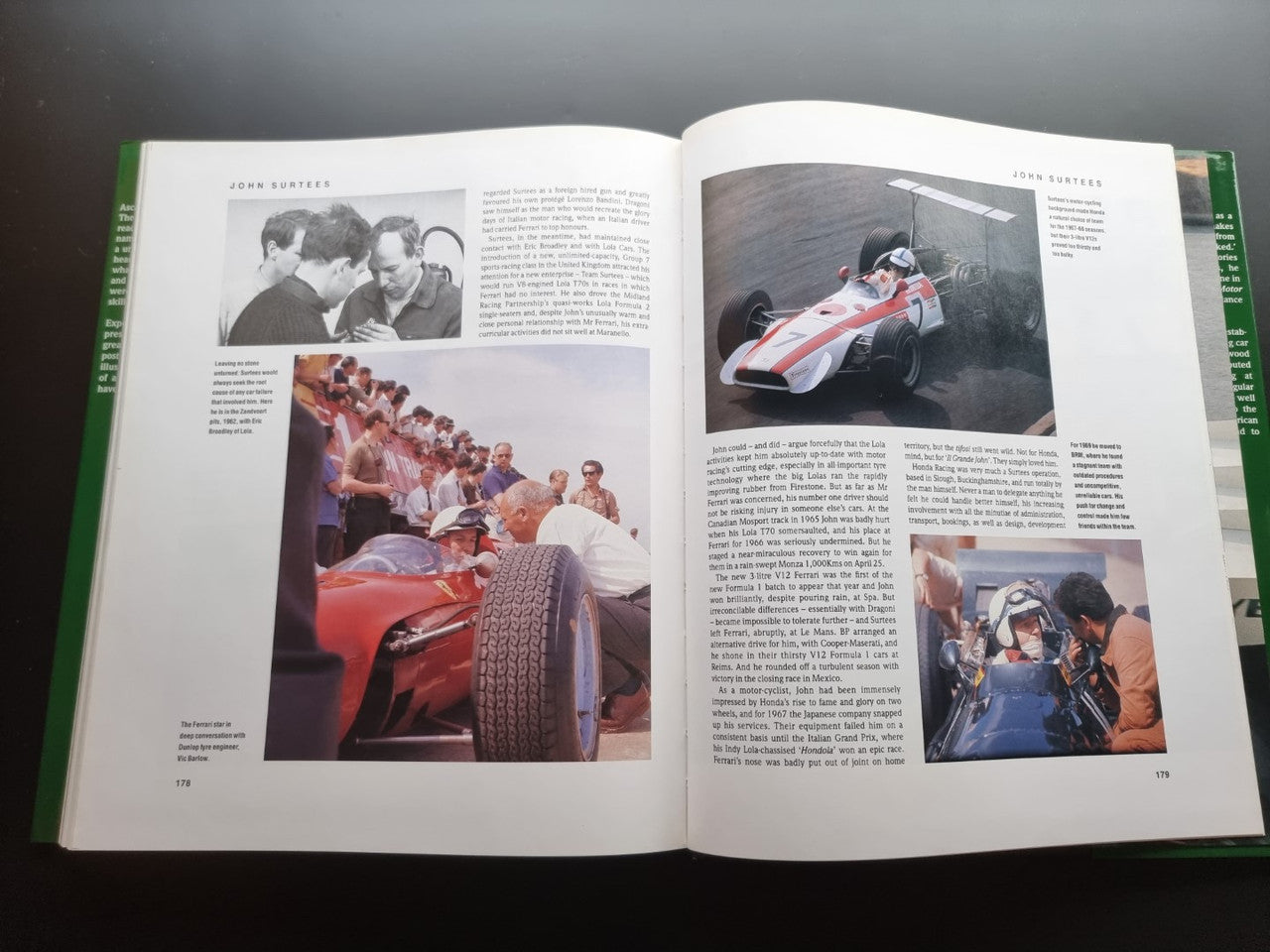 Open motorsport history book with black-and-white team photos and a red racing car image