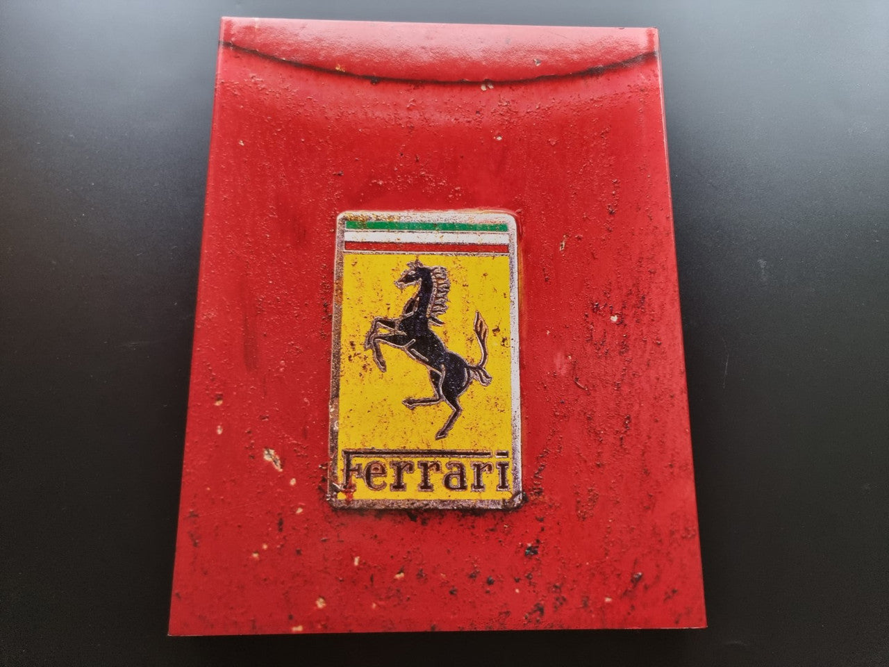 Ferrari year book cover with red textured surface and Ferrari crest
