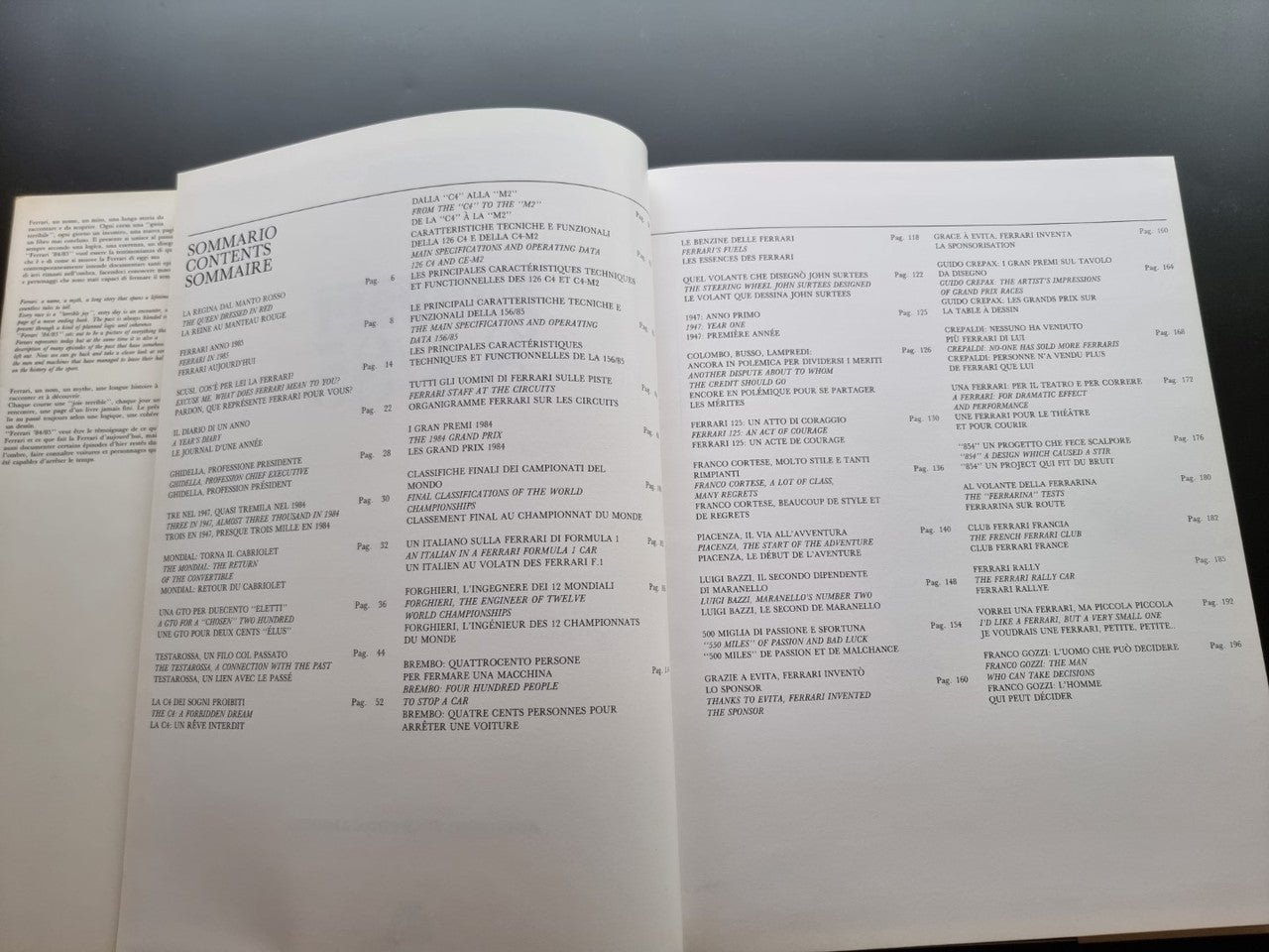 Ferrari year book opened to two pages of small text, cream paper