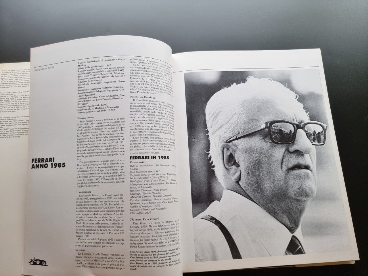 Ferrari year book opened to pages with text and a black-and-white portrait