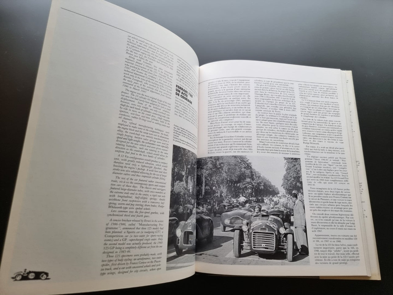 Ferrari year book opened to an article page with a vintage car photo
