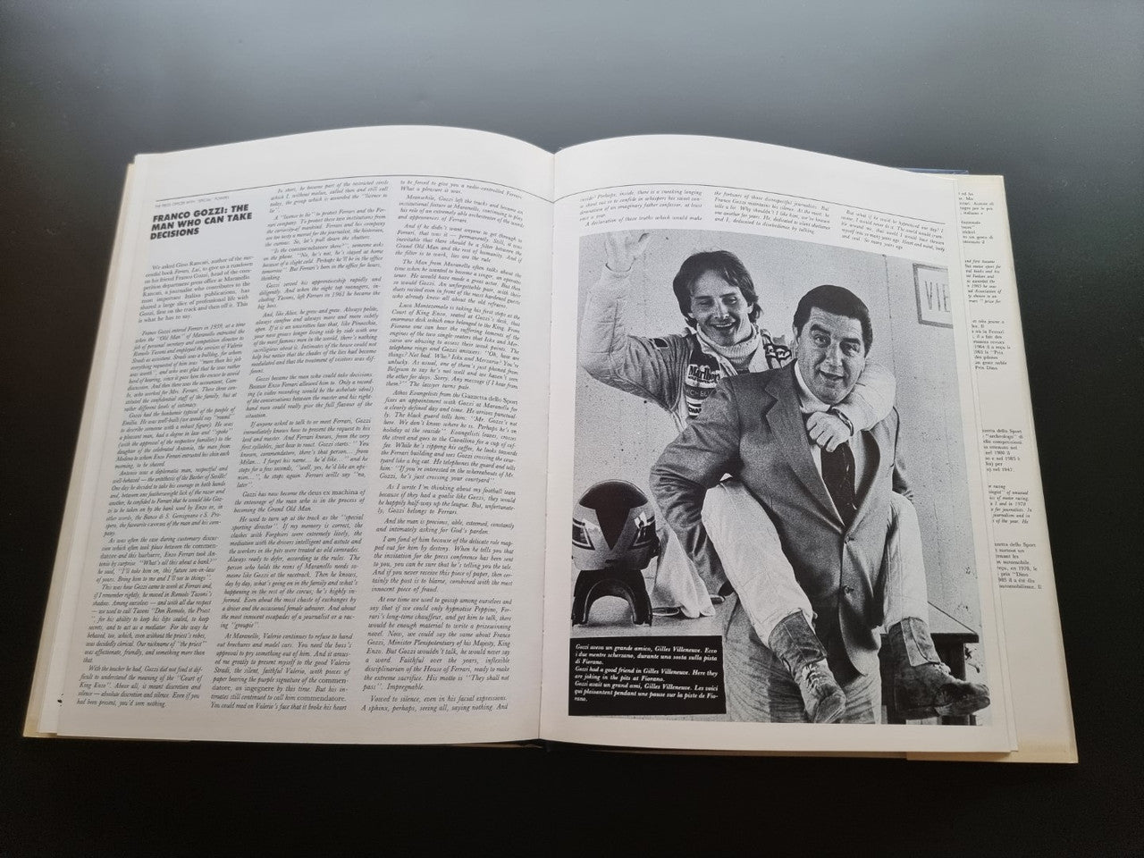 Open year book with large black-and-white photo of two men
