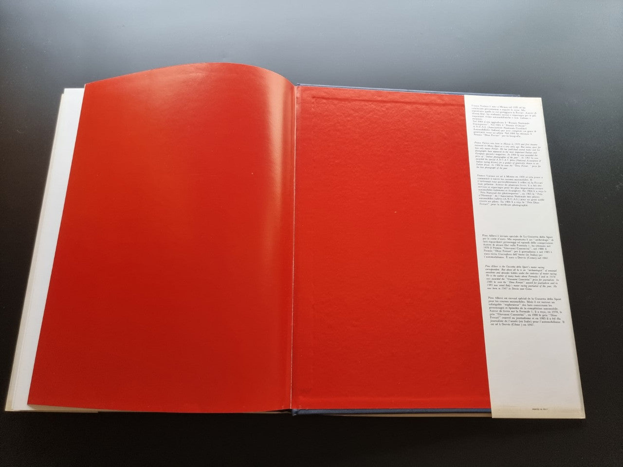 Ferrari year book with red covers and white inner pages, opened
