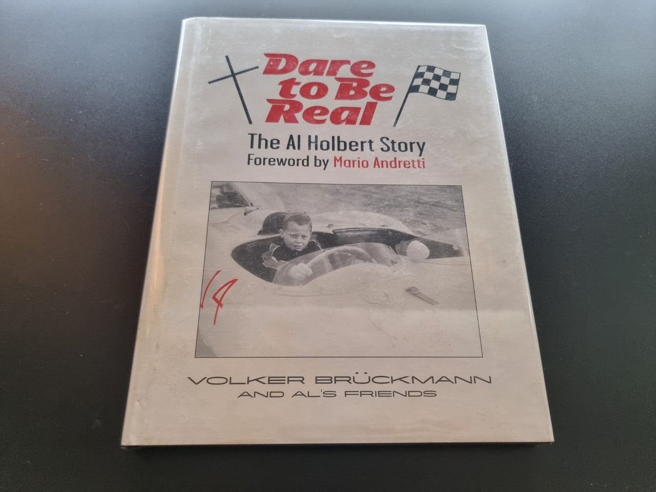 Hardcover book cover with title, forward by credit, and racer photo