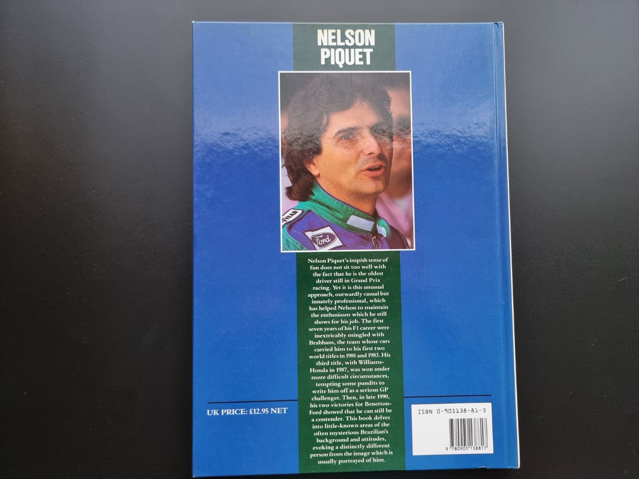 Motorsport book back cover with portrait photo, green text block, and barcode