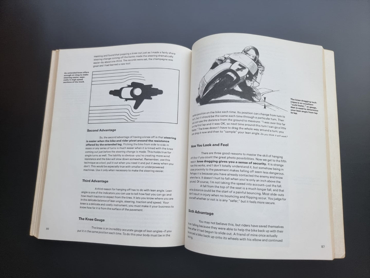 Open book pages with illustrations, icons, and paragraphs of printed text