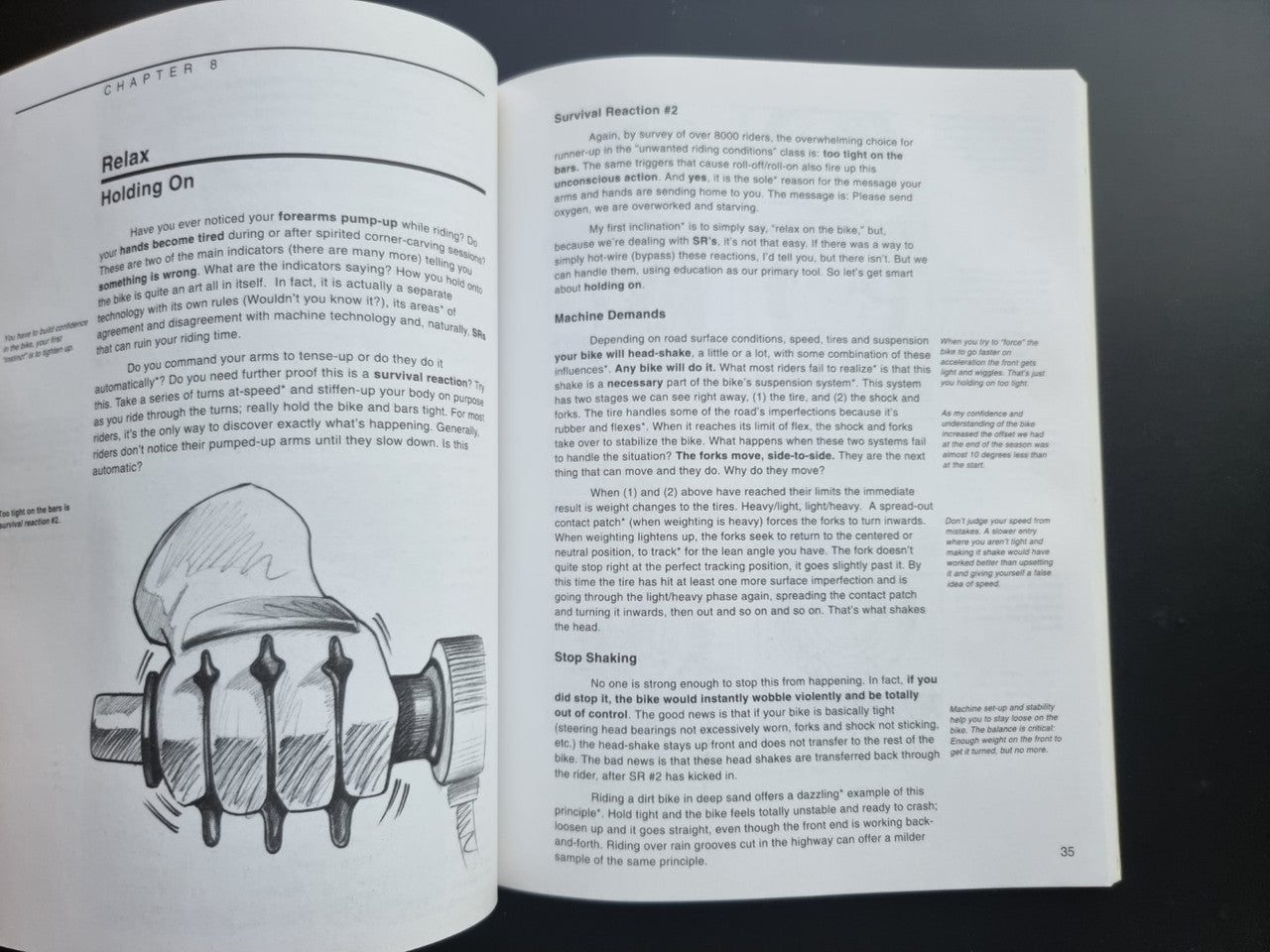 Motorcycle riding guide paperback, open spread with Holding On chapter and hand/gear illustration.