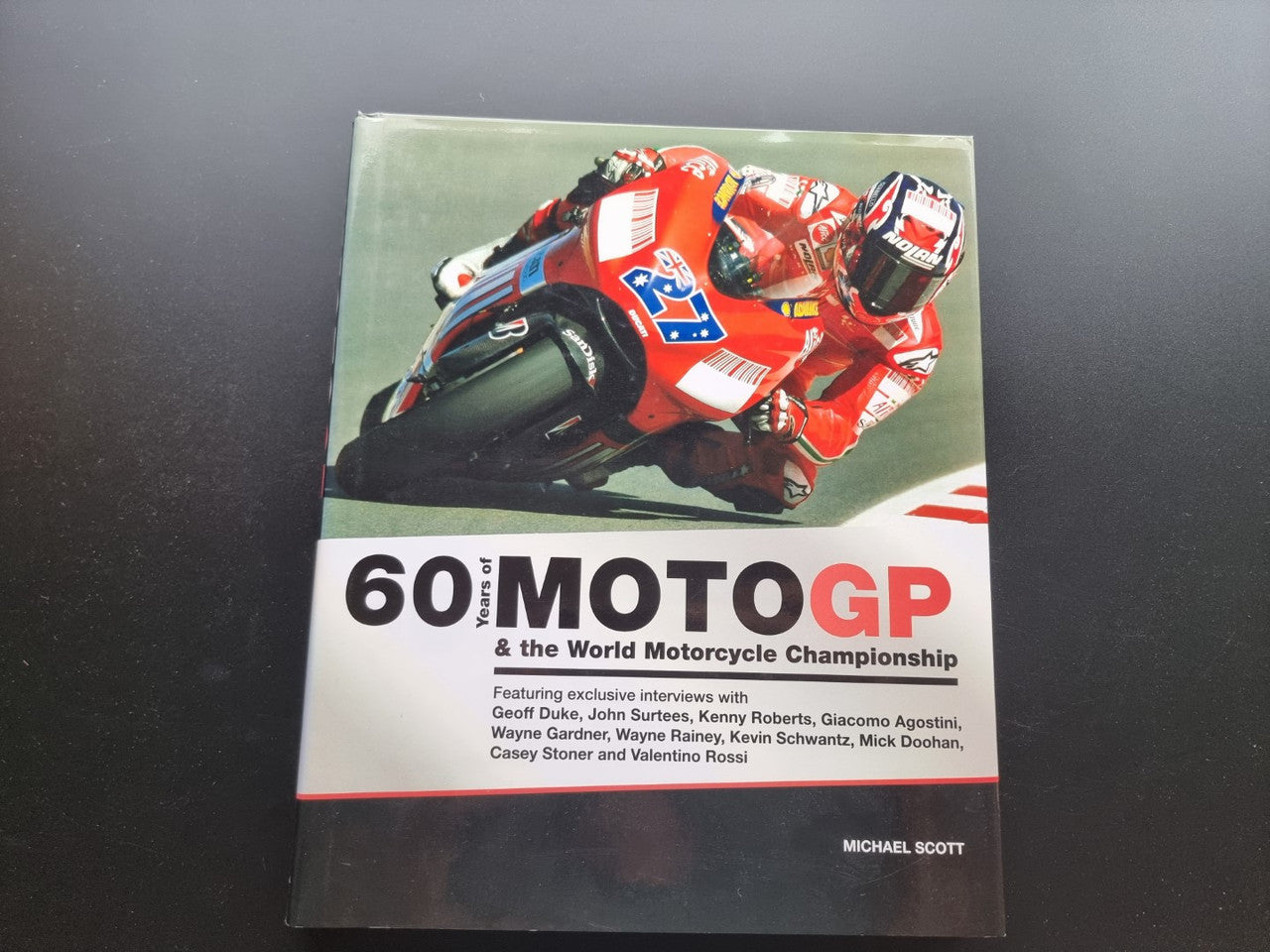 Paperback book cover with red racing motorcycle and large MotoGP title