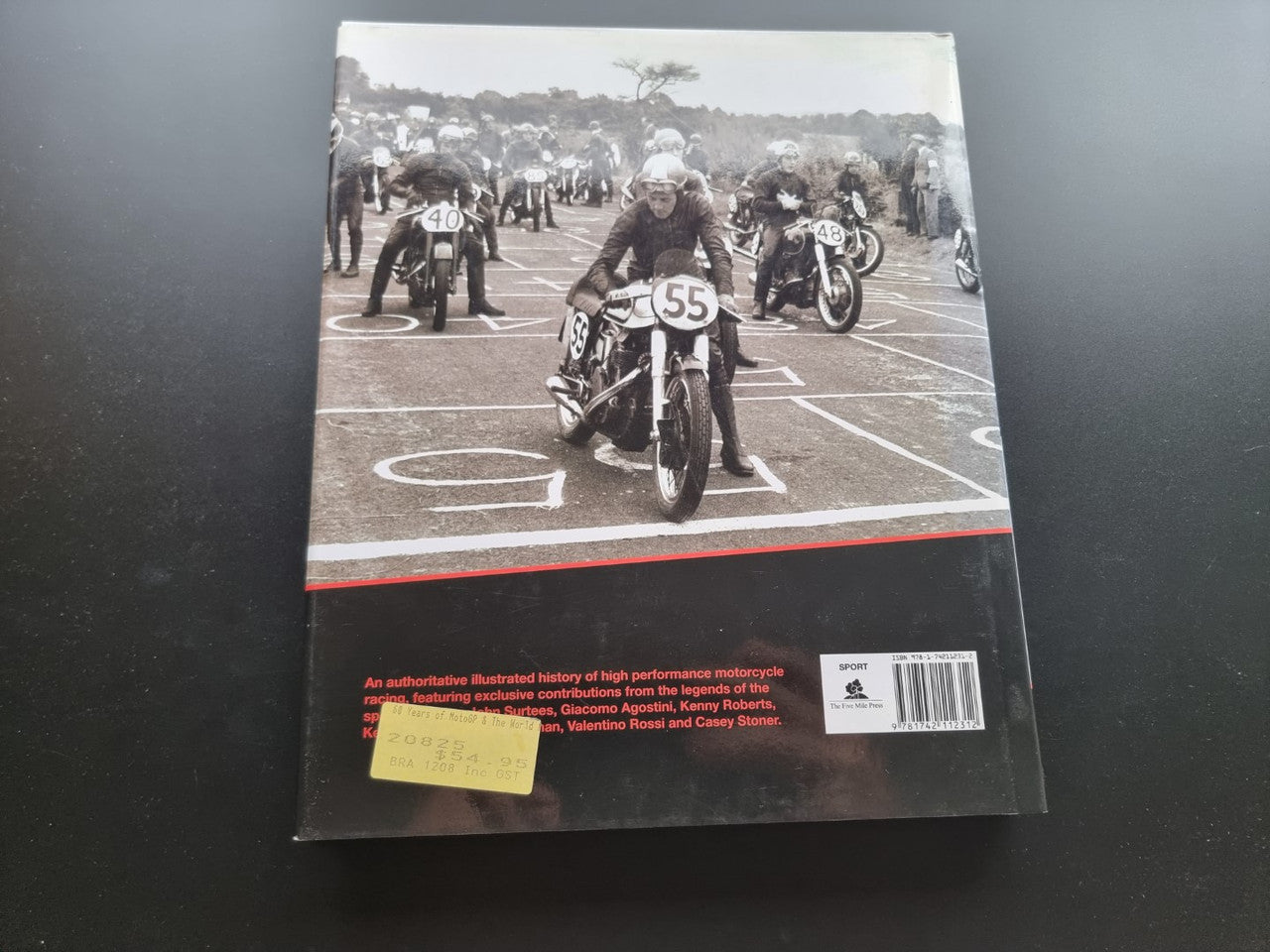Motorsport history book back cover with black-and-white rider photo and red stripe