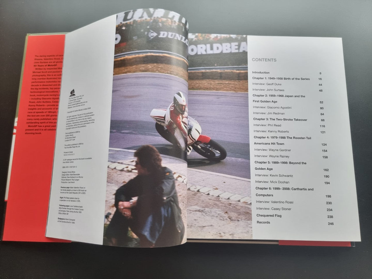 Motorsport history book, open to contents page with motorcycle racing photo spread