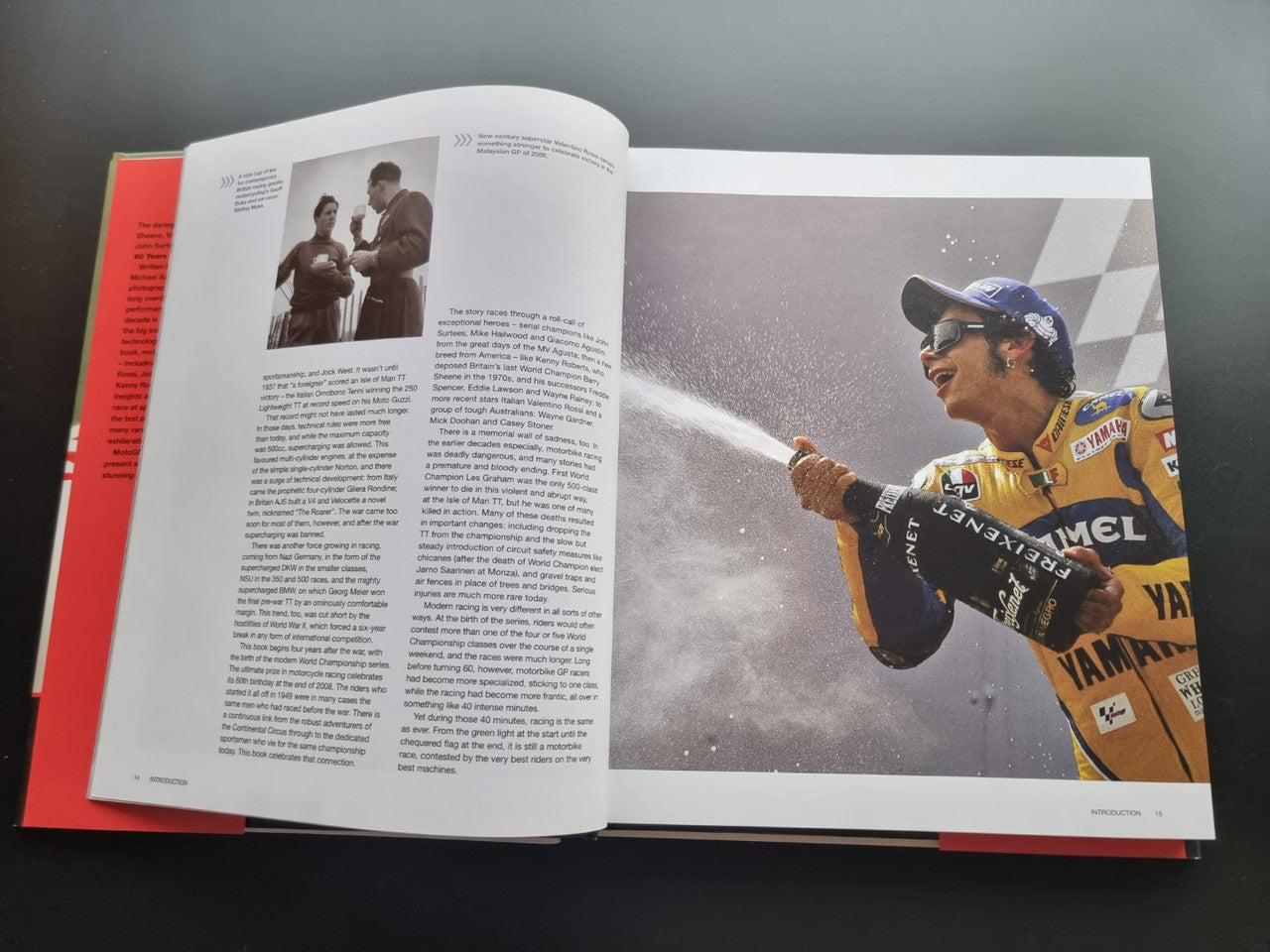 Motorsport history book, open pages with motorcycle racer portrait and action photo