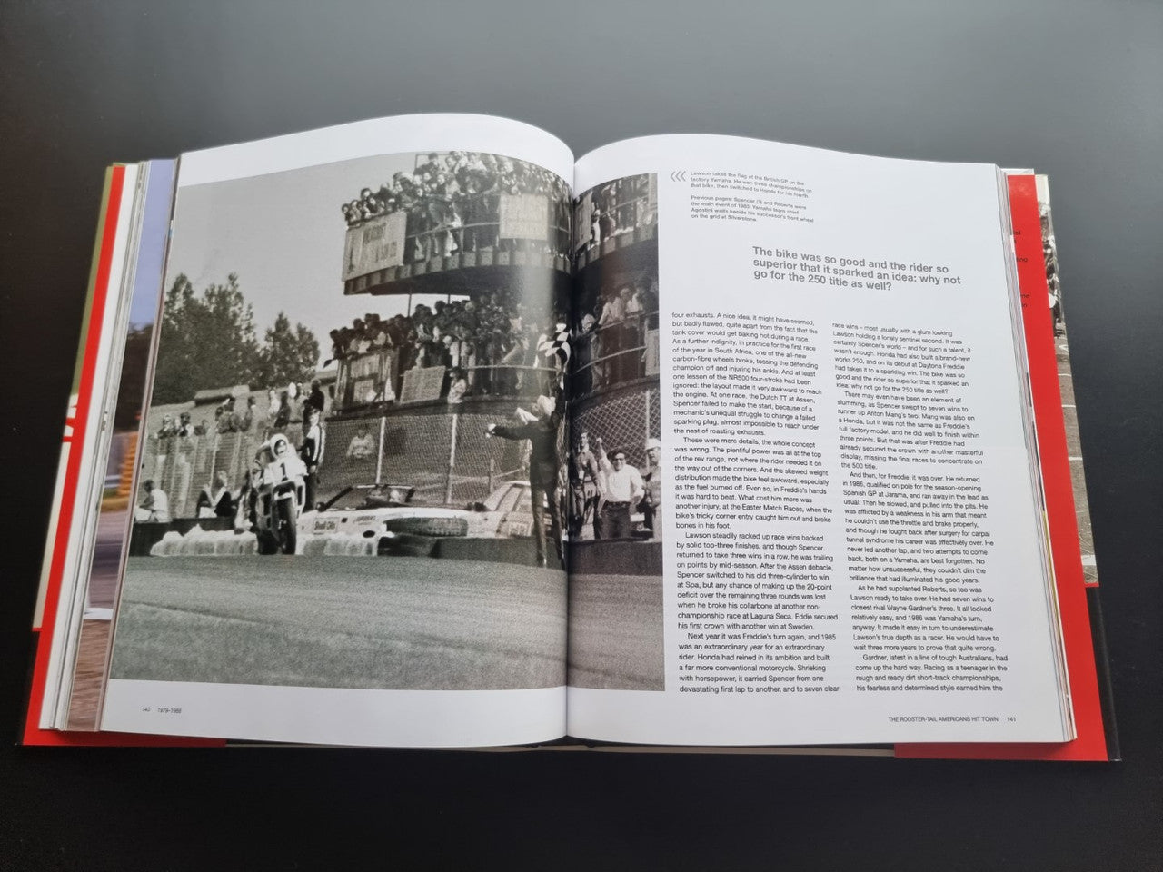 Motorsport history book, open spread with black-and-white crowd and track photo