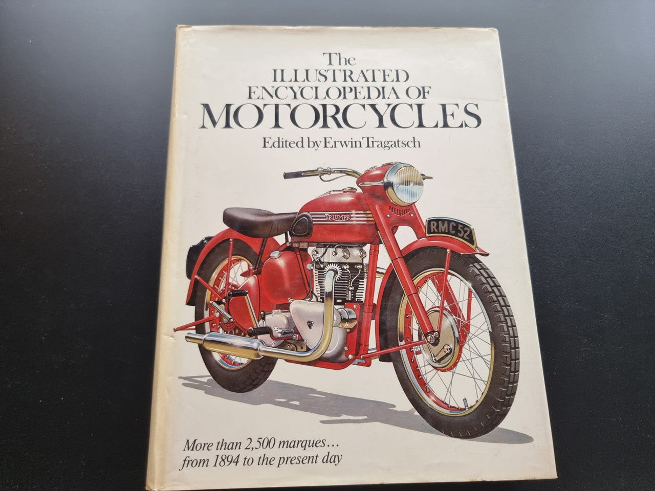 Motorcycle encyclopedia book with red classic motorcycle on cover