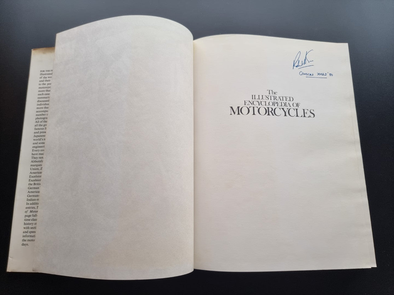 Open book with title page reading The Illustrated Encyclopedia of Motorcycles