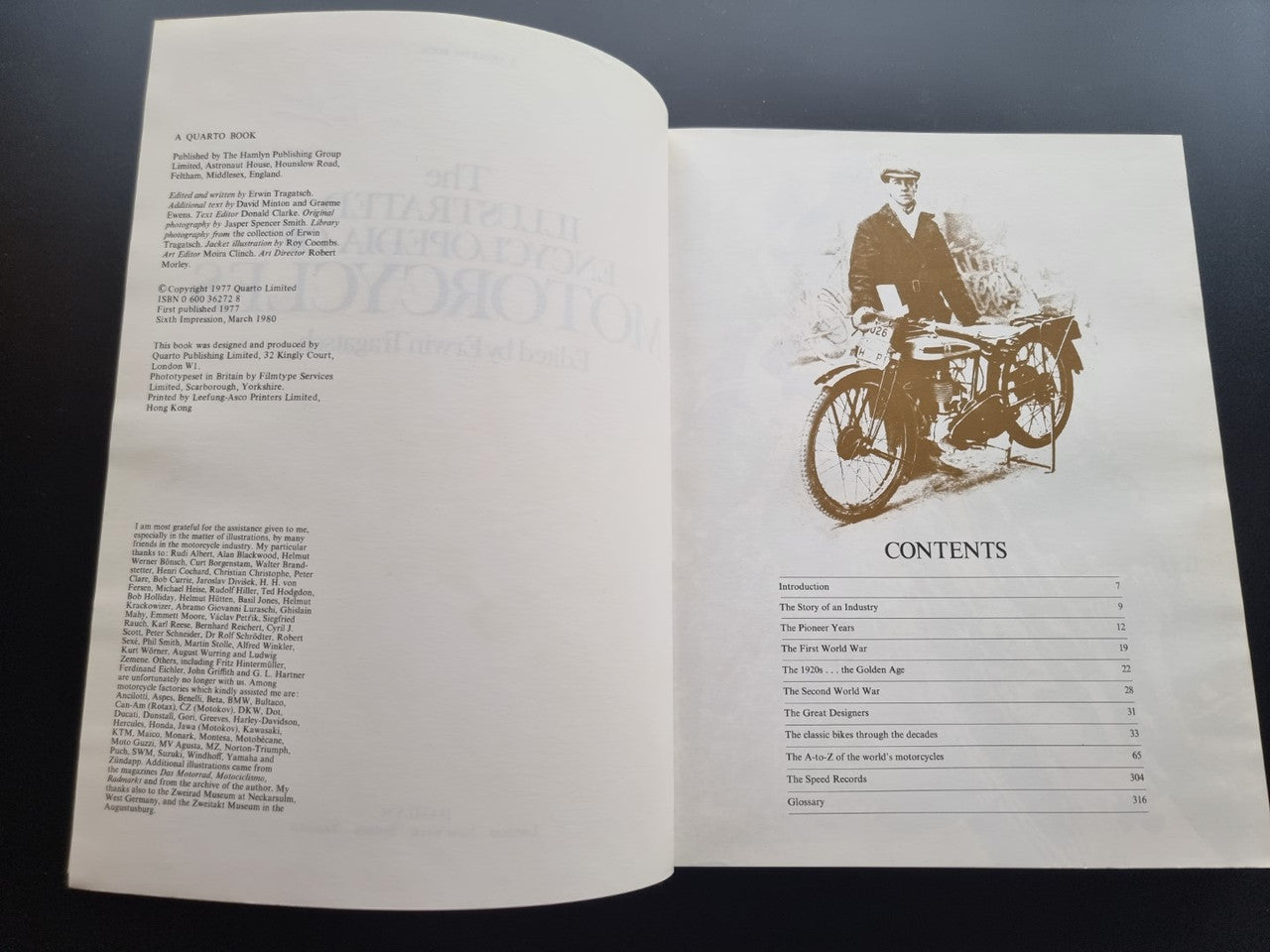 Open book showing contents page with small motorcycle illustration