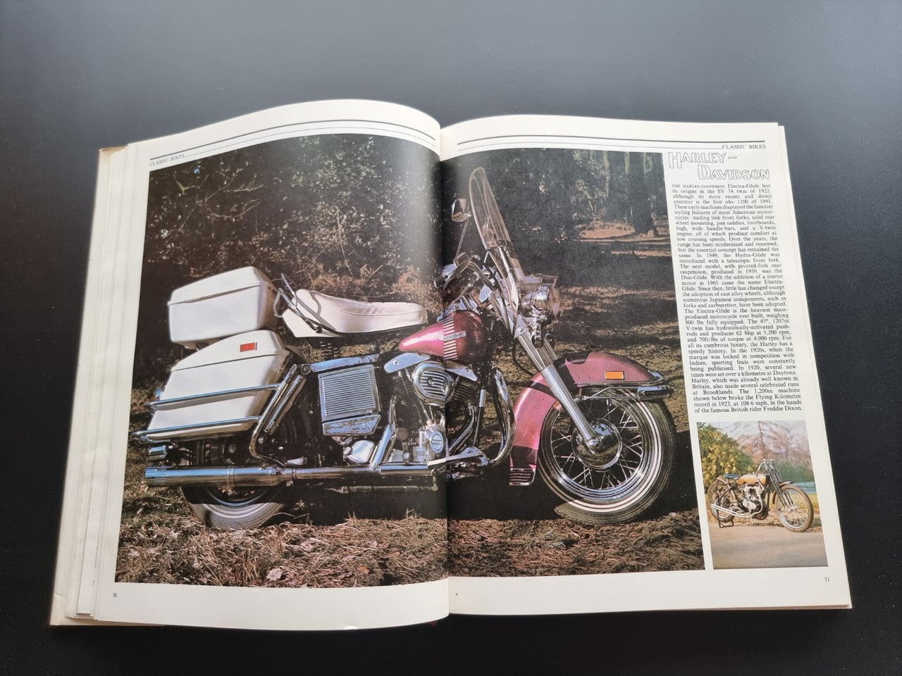 Open book showing color photo of a motorcycle with surrounding text