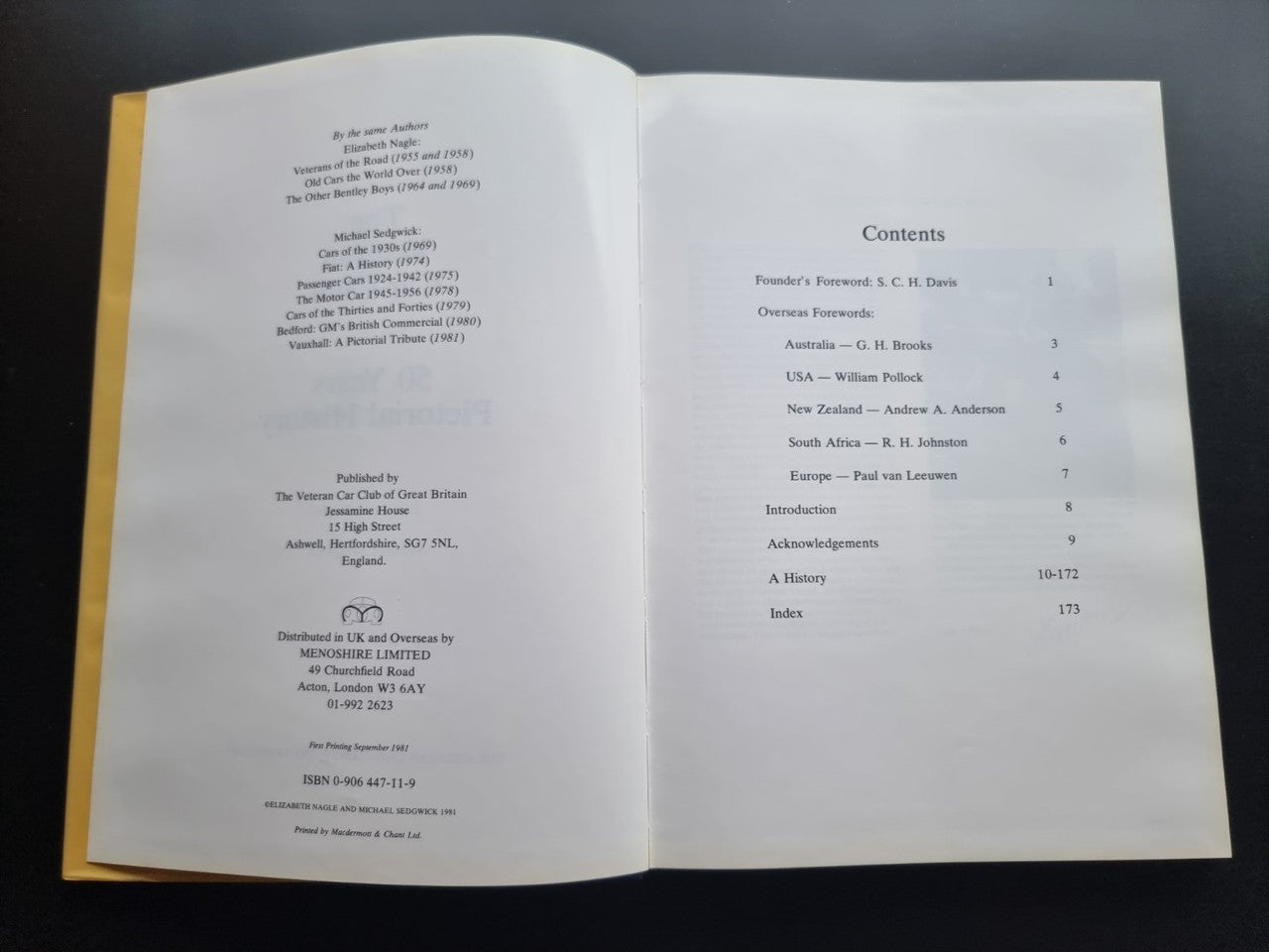 Open pictorial history book pages with text and table of contents