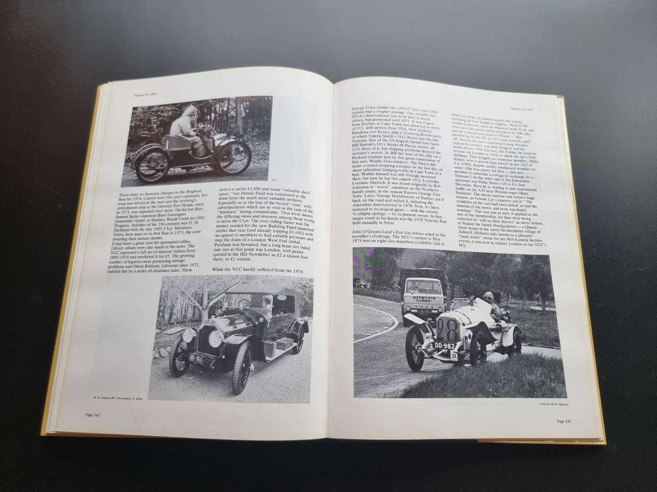 Open pictorial history book spread with vintage close-up car photos