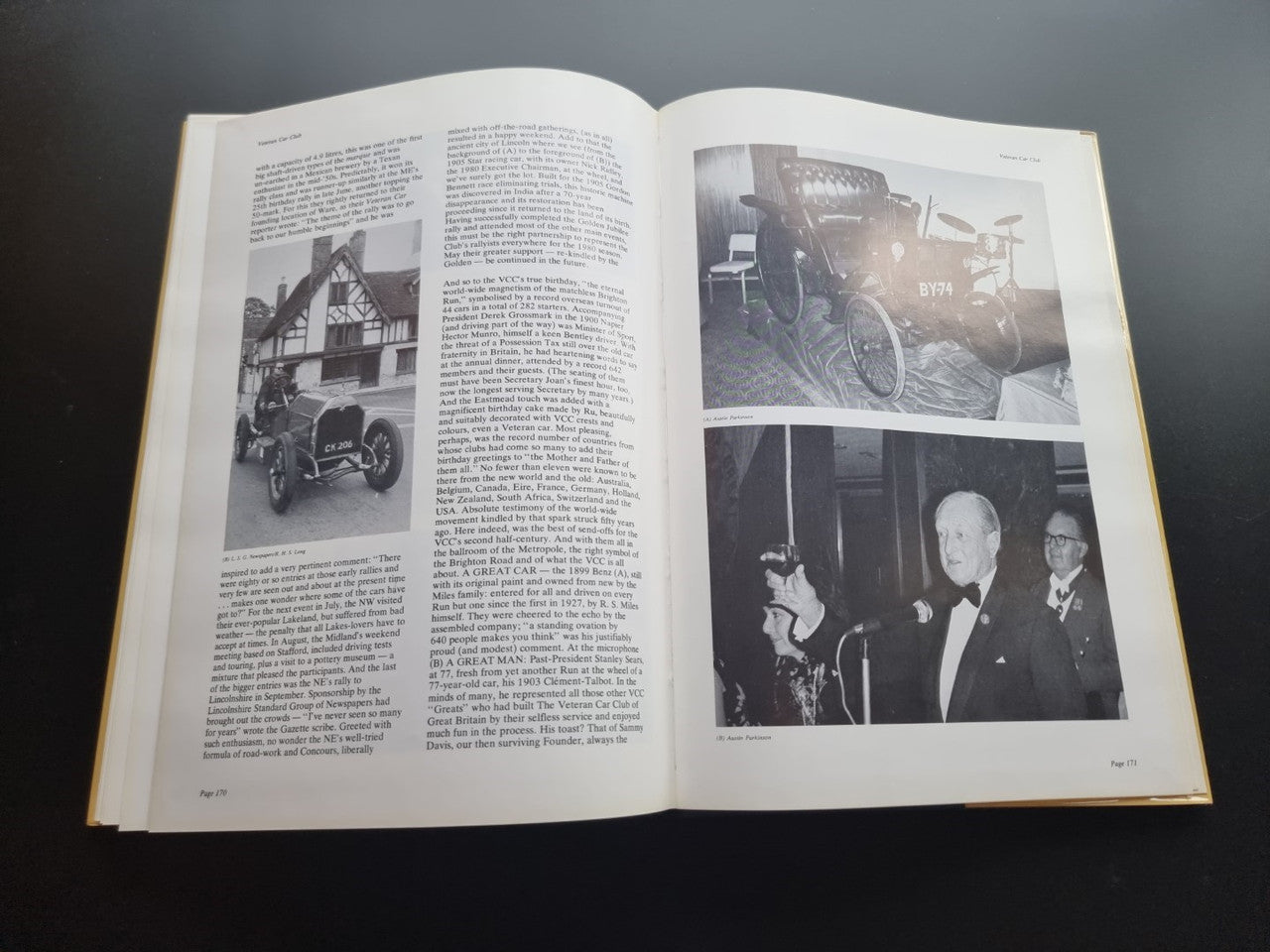 Open pictorial history book spread with vintage vehicle photos and captions