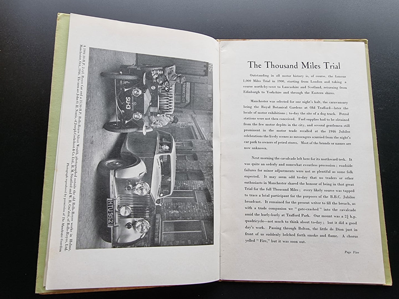 Opened book with black-and-white photo on left page and article text on right.