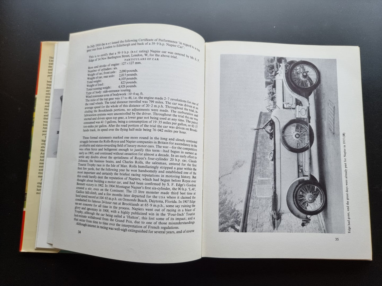 Open book spread with text pages and a black-and-white photo of vintage car instruments.