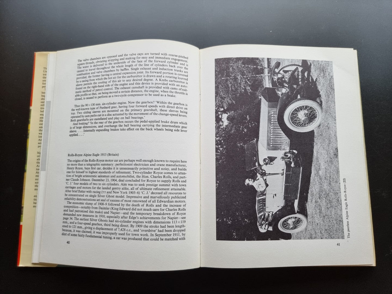 Open book spread with text pages and a black-and-white photo of a car detail at right.