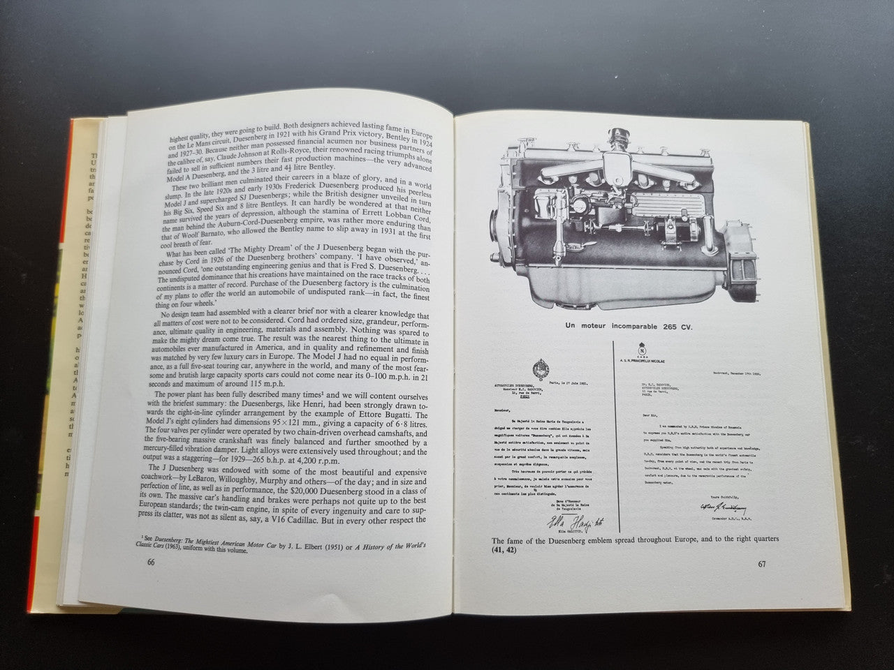 Open book with text and a labeled technical diagram of a vintage car engine.