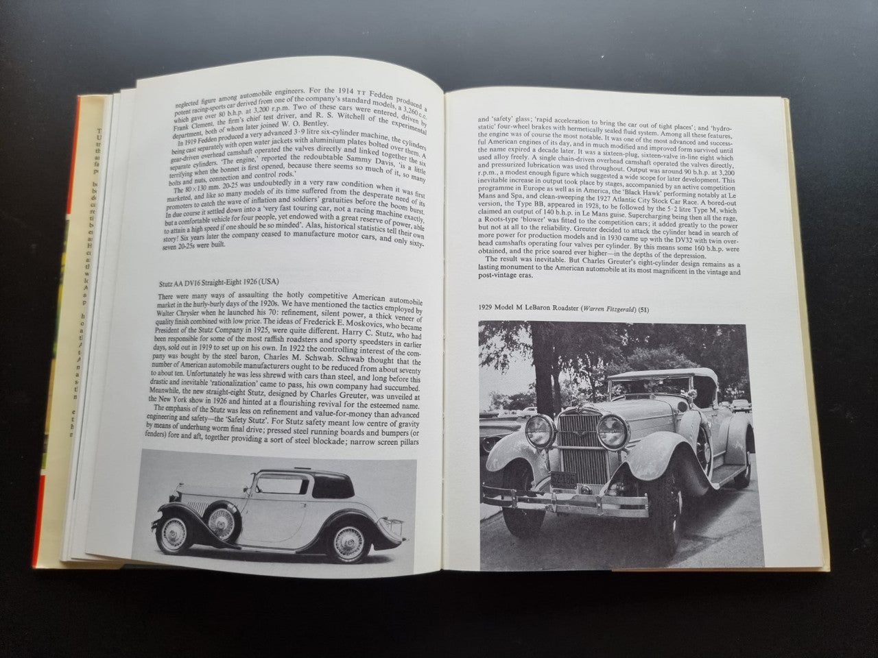 Open book page spread with paragraphs and black-and-white photos of vintage cars.