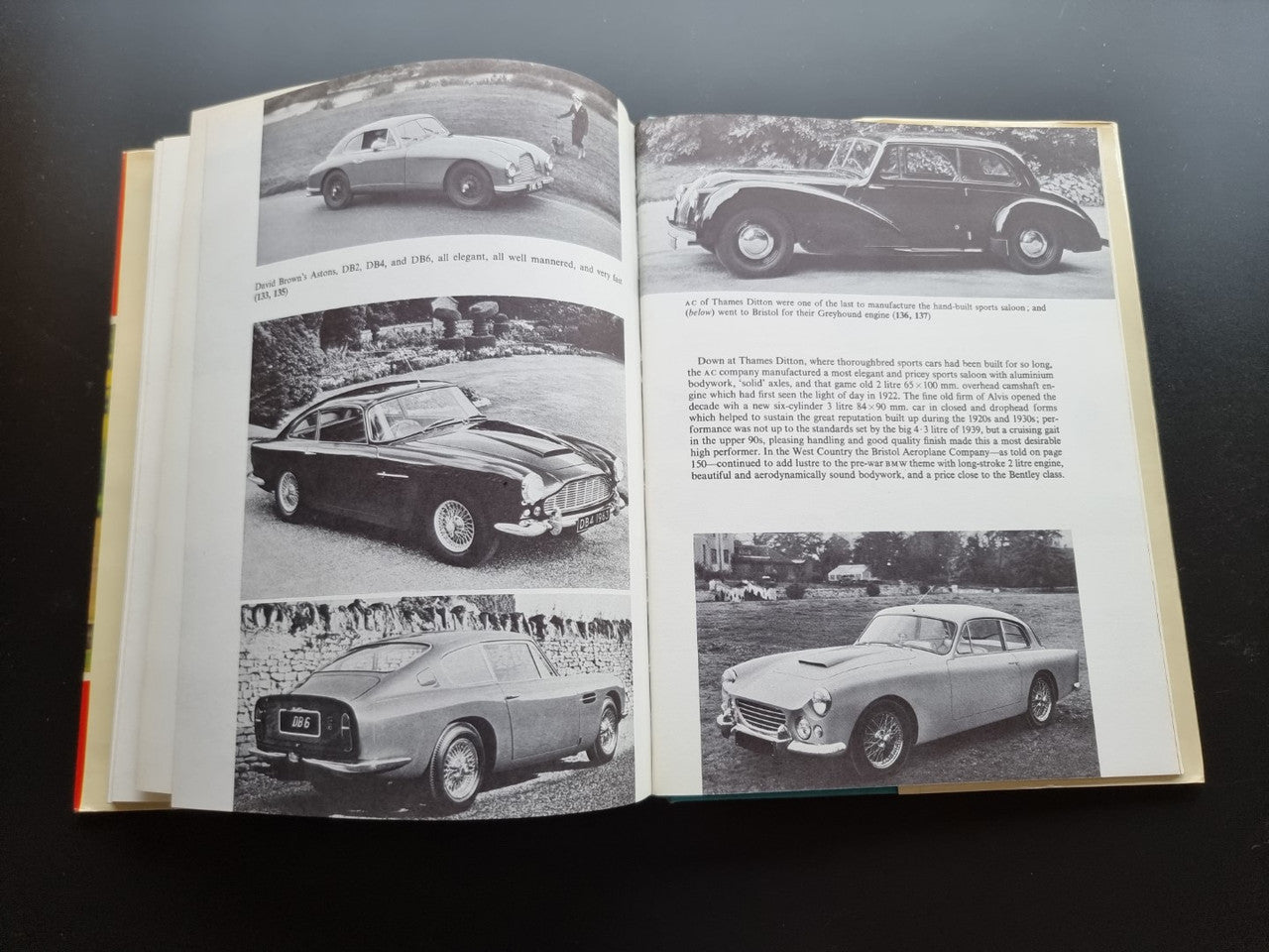 Open book with multiple black-and-white photos of vintage cars arranged across two pages.