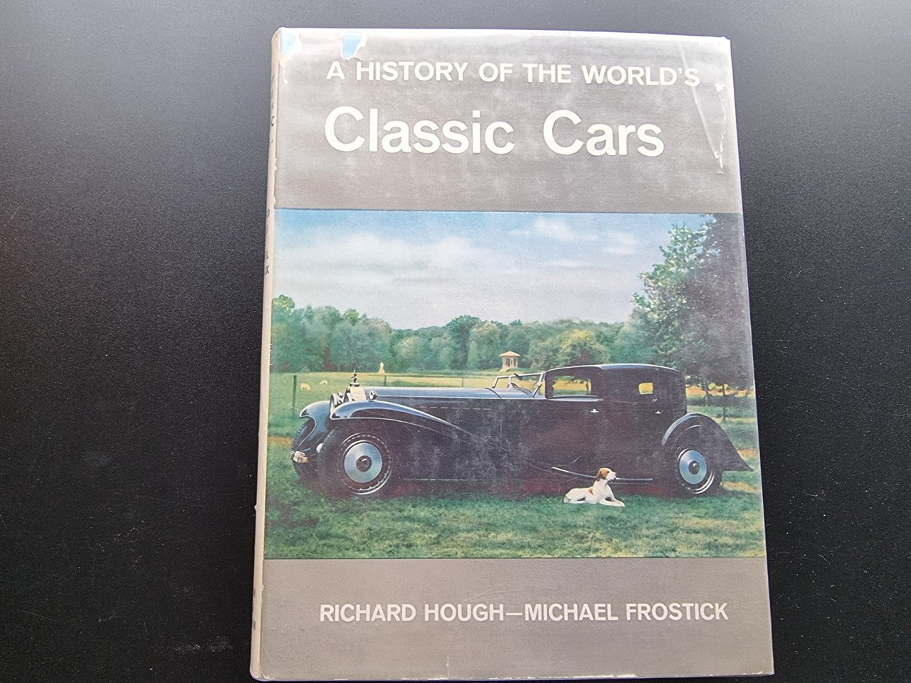 Classic car history book cover with title and classic car on a grassy lawn