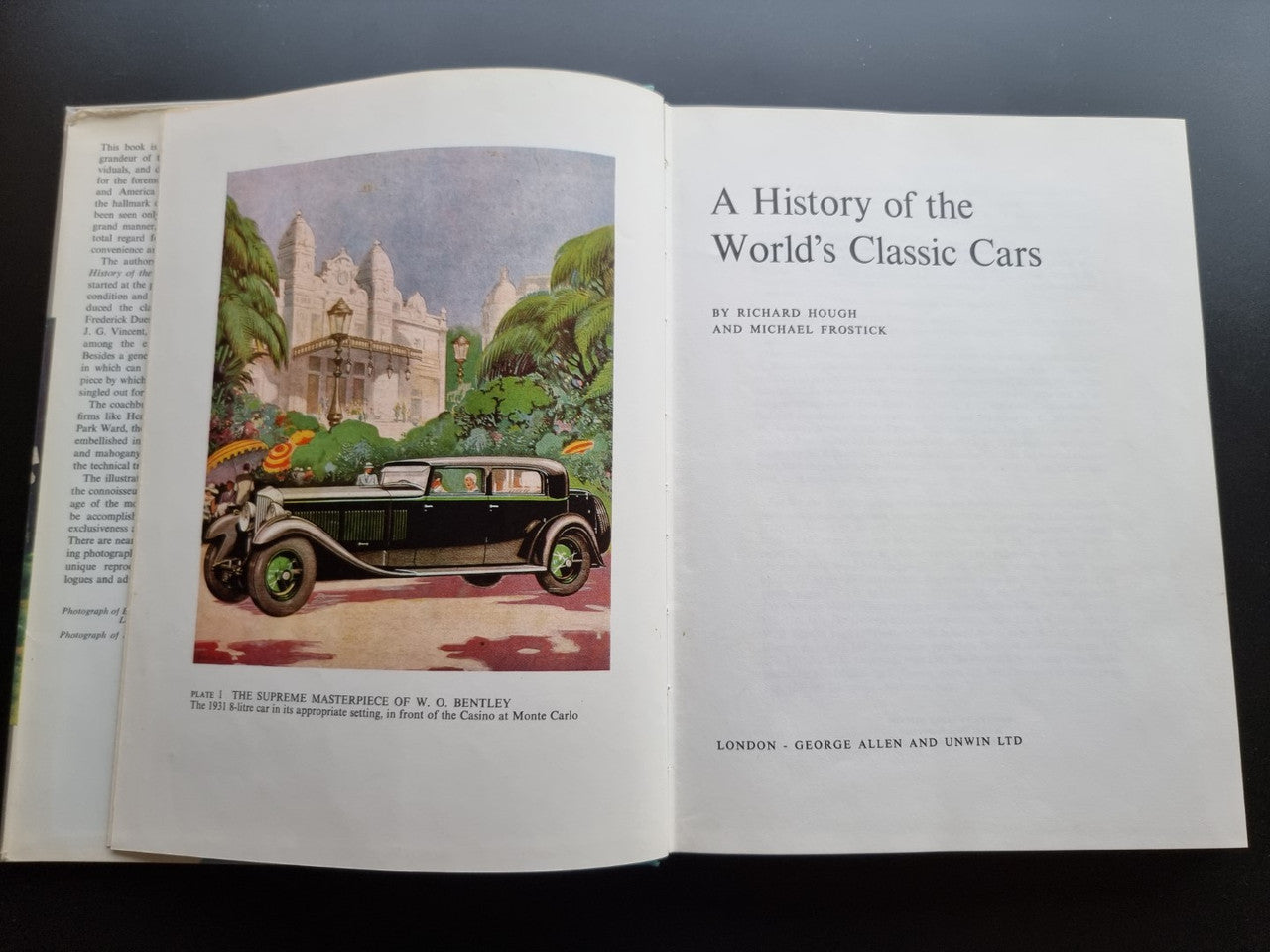Classic car history book open with title page and a colored car illustration