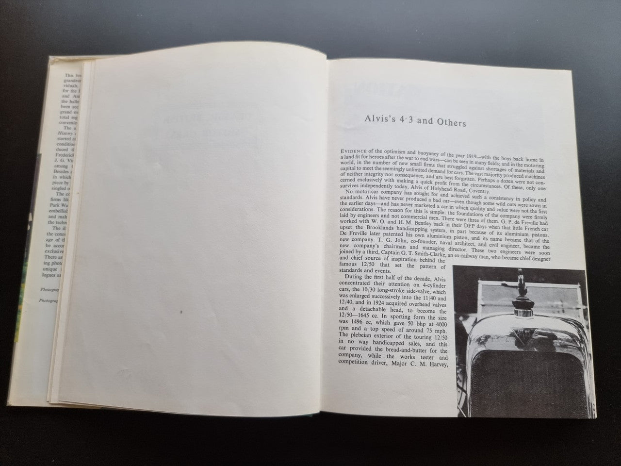 Classic car history book open to an illustrated page with a vintage car scene