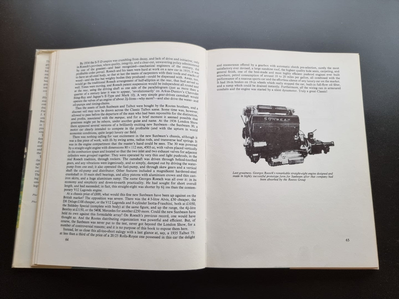 Classic car history book open with text and a vintage truck photograph