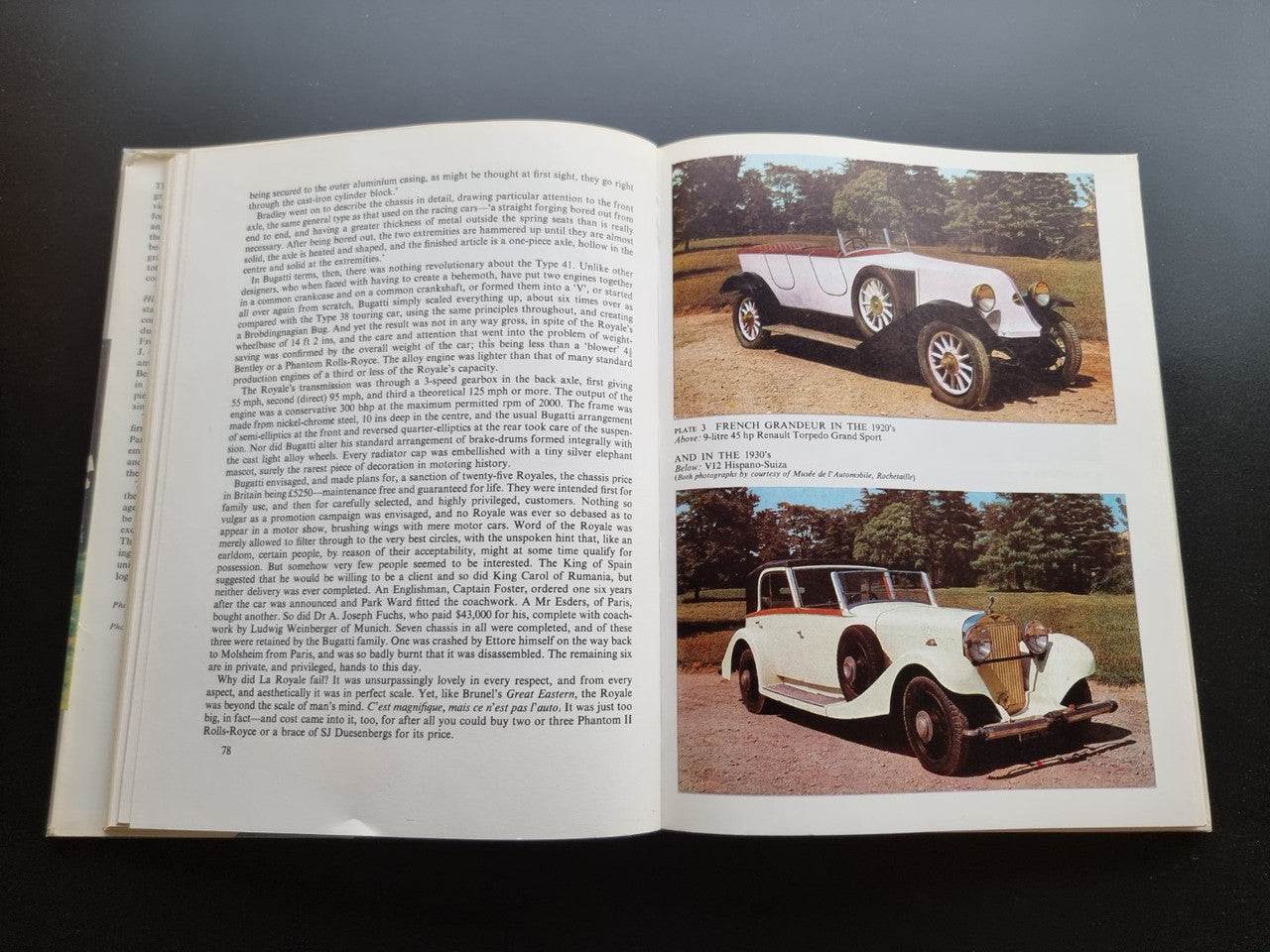 Classic car history book open to car photo spread with two color vehicle images
