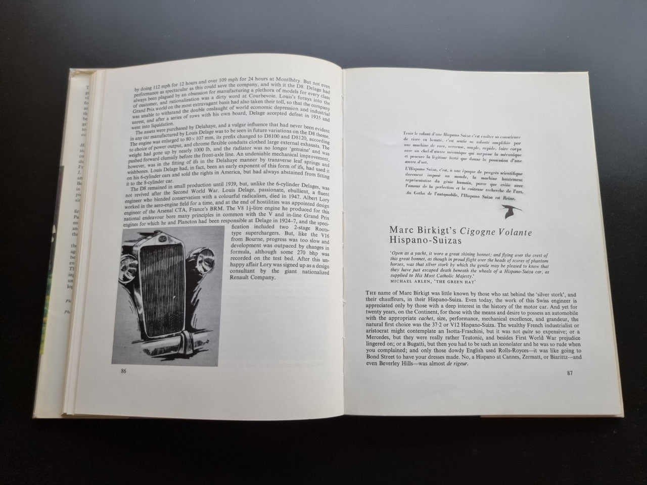 Classic car history book open with a vintage car photo and section text