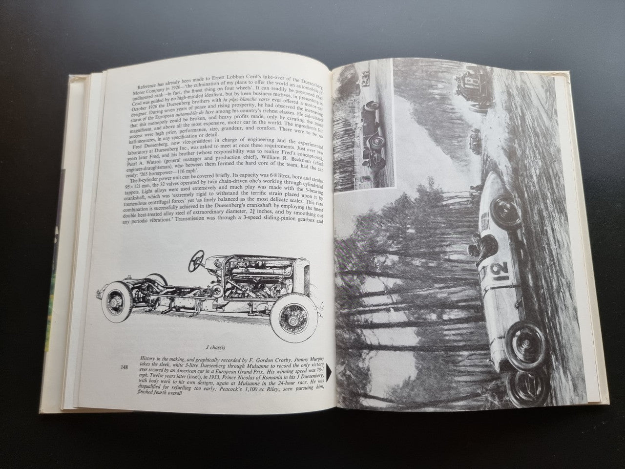 Classic car history book open to a car diagram and black-and-white vehicle photo