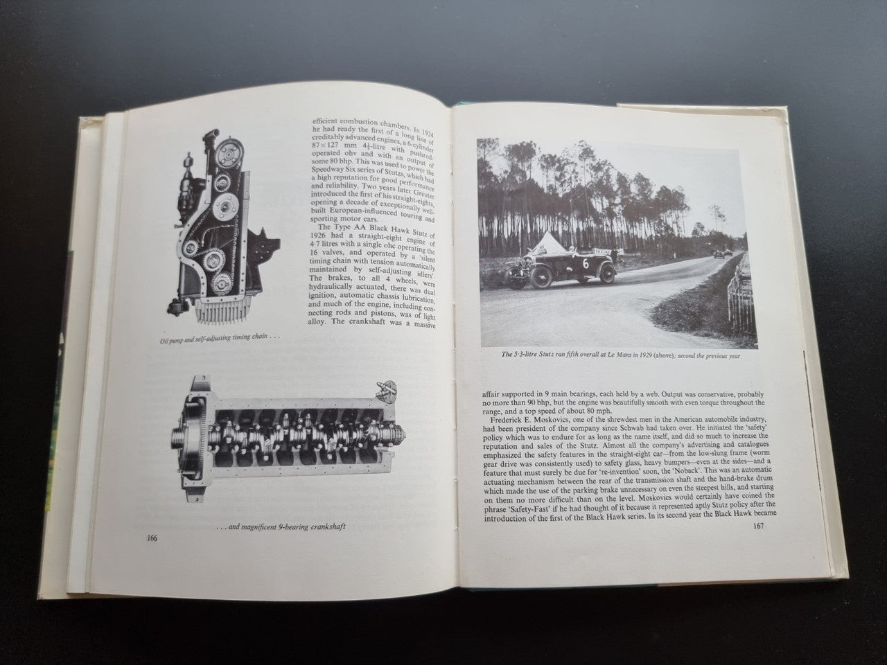 Classic car history book open with diagrams and a roadside vehicle photo