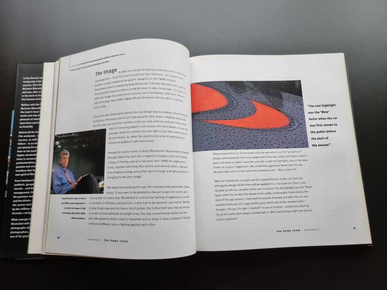 Formula One team biography book, open pages with orange logo detail