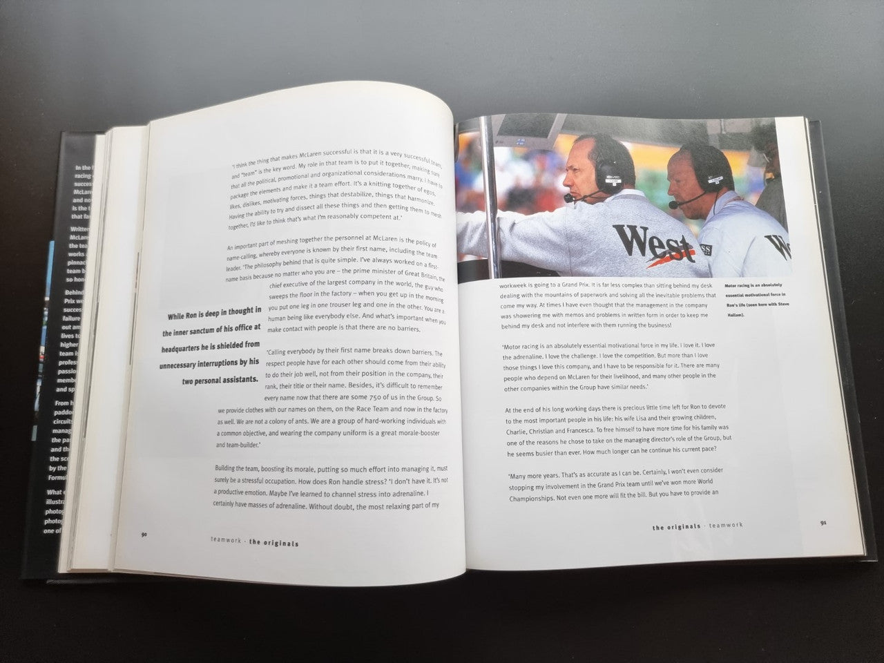 Formula One team biography book, open pages with team photo and text